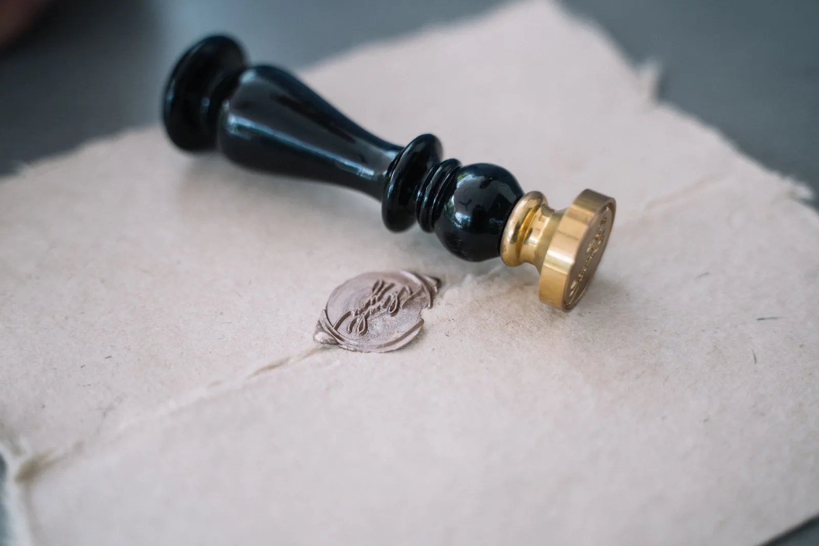 Close-up of vintage sealing wax and stamp on an old-fashioned envelope. How to put after-hours fees on a traveling notary rate card