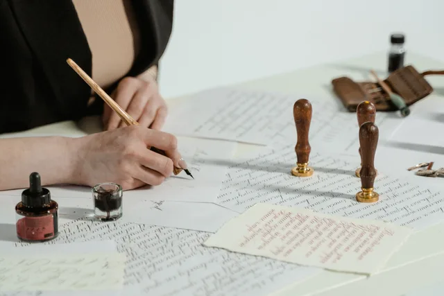 Artistic calligraphy writing with vintage seals and ink on paper. Denver mobile notary signings: onboarding and the fee cap